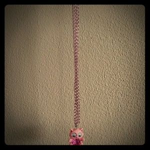A kitty kat necklace with fake gem in middle